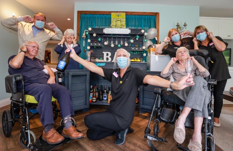 RESIDENTS CLINK GLASSES AT IN-HOUSE BAR AFTER SPONSORED SILENCE