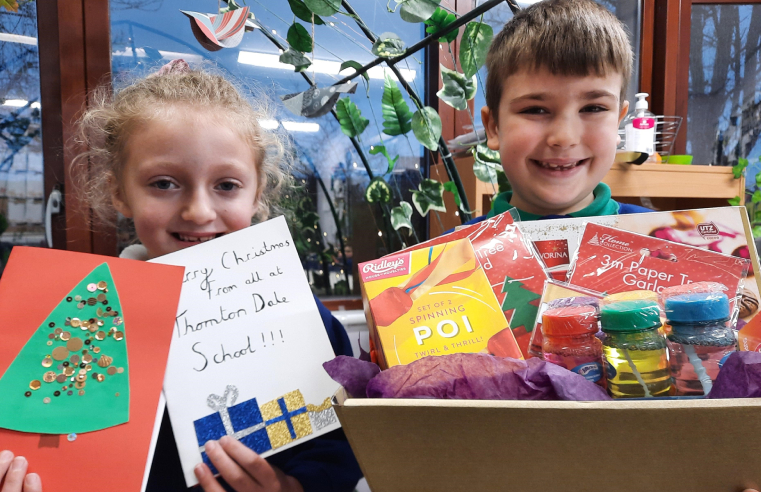 Year-2 students at Thornton Dale Primary School deliver Christmas presents to The Hall