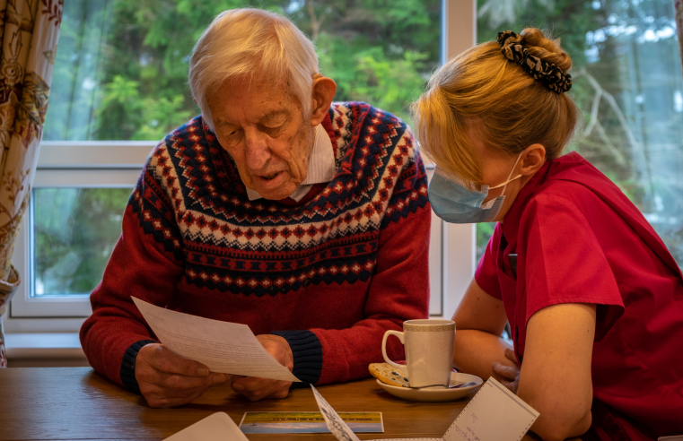 Resident Sir Jack Shaw reading pen pal letter from America