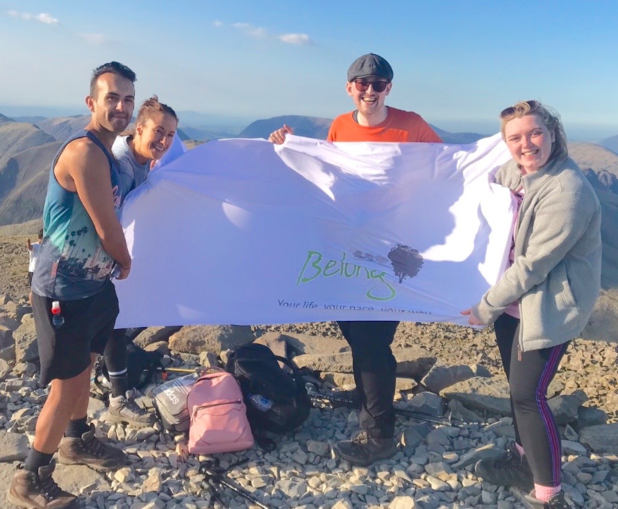 (L-R) Daniel Gwilliam, Rachel Pepperdine, Andrew Stratford and Melissa Jones holding the Belong flag at the top of the summit.