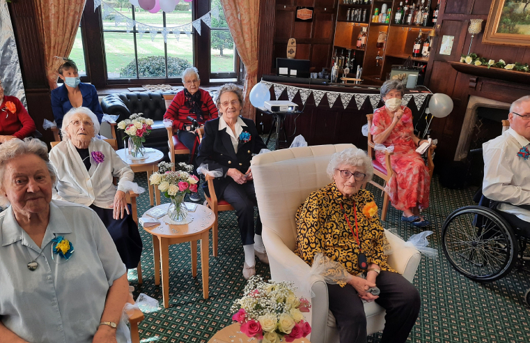 : RMBI Home Prince Edward Duke of Kent Court resident Dot Bash (wearing a yellow patterned blouse) watching a live stream of her granddaughterâ€™s wedding with fellow residents. 