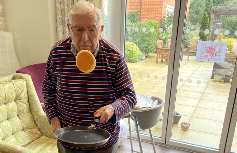 Resident Andre Mauger enjoying pancake flipping.